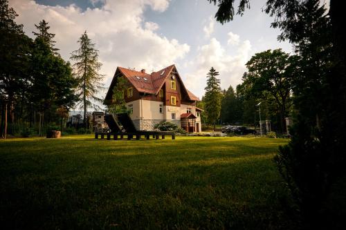 a house sitting on top of a lush green field at Stacja Szklarska Poręba - cisza i komfort in Szklarska Poręba