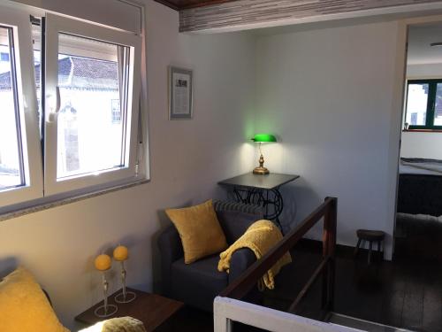 a living room with a couch and a window at King Garfield House - Espaço de charme em Bragança in Bragança
