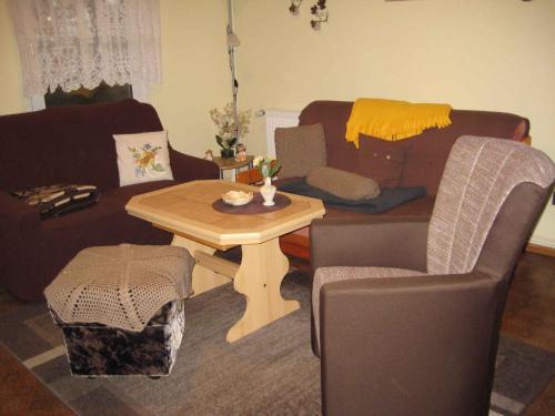 a living room with a table and a couch at Holiday home Groß Kordshagen - Ostsee 2741 in Groß Kordshagen