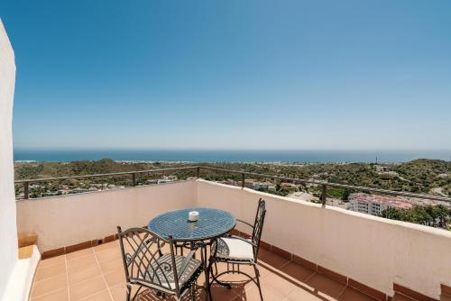 a balcony with a table and chairs and the ocean at Boutique Hotel Mamabels in Mojácar