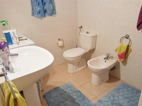 une salle de bain avec des toilettes blanches et un lavabo dans l'établissement FAVONA, à Conca