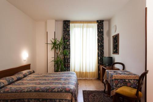 Postel nebo postele na pokoji v ubytování Hotel Fabbrini