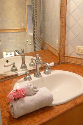 a bathroom sink with a towel and a mirror at La Dolce Vista - B&B di Charme in Manfredonia