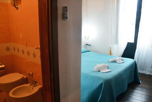 a bathroom with a bed with a sink and a toilet at L'Antico Sogno Guest House in Tramutola