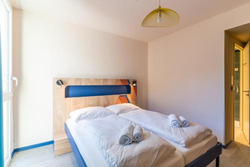 a bedroom with a bed with towels on it at MEININGER Marseille Centre la Joliette in Marseille