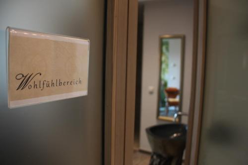 a sign on the door of a room at Gasthof-Pension Zum Haugstein - Familie Eder in Engelhartszell