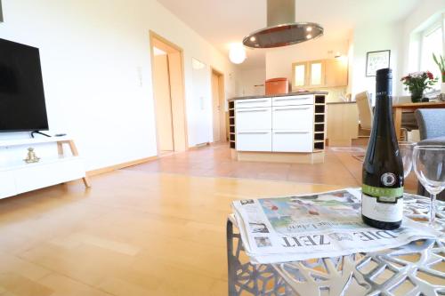 a living room with a bottle of wine on a table at Gutenberg - helle und geräumige Wohnung nahe der historischen Altstadt in Mainz