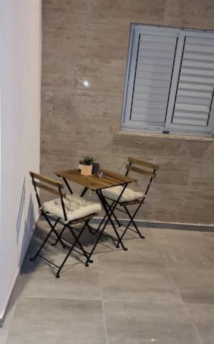 two chairs and a wooden table and a table and chairs at Luxury Queen Mountian in Eilat