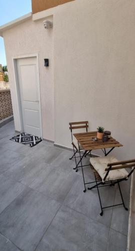 a patio with a table and chairs and a door at Luxury Queen Mountian in Eilat