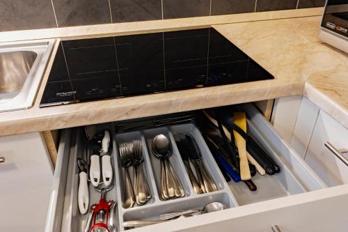 a drawer filled with utensils in a kitchen at Residenza IL CASTELLO in Sondrio