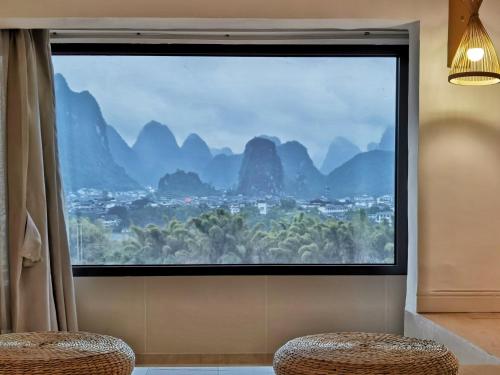 a large window with a view of a city at Riverside Retreat Hotel in Yangshuo