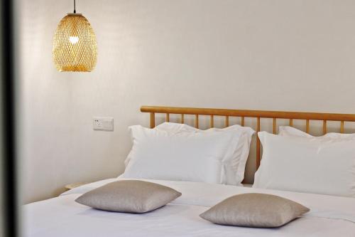 a bedroom with two pillows on a white bed at Riverside Retreat Hotel in Yangshuo