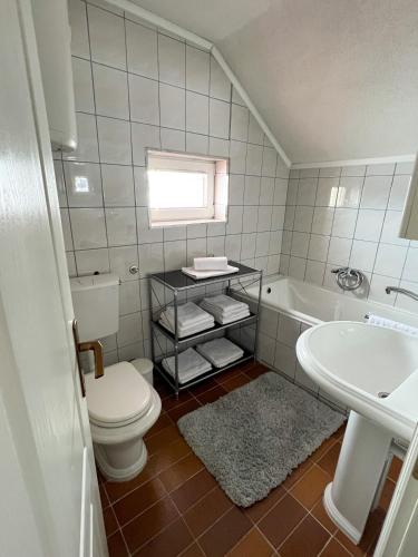 a bathroom with a toilet and a sink and a tub at Kuća za odmor IVKOVIĆ in Kupres