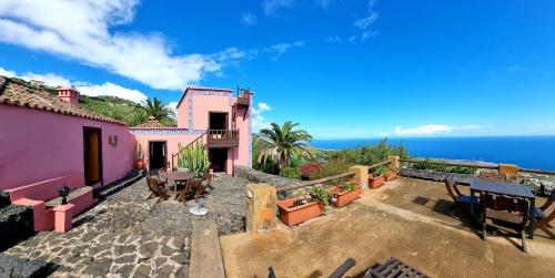 a house with a patio with a view of the ocean at Celeste in Mazo