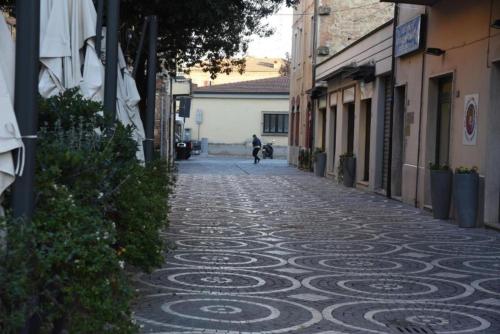 een persoon die over een geplaveide straat loopt bij TRE ARCHI HOUSE in Chiusi