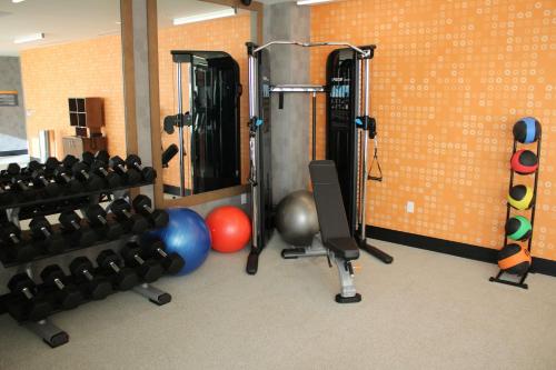 a gym with a bunch of weights and balls at La Quinta Inn & Suites by Wyndham Bardstown in Bardstown