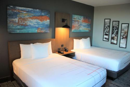 two beds in a hotel room with white sheets at La Quinta Inn & Suites by Wyndham Bardstown in Bardstown
