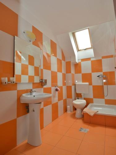 a bathroom with a sink and a toilet at Pensiunea Marina in Bran