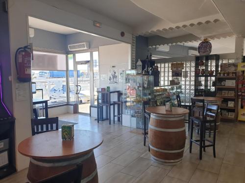a bar with tables and chairs in a restaurant at Complejo Hotelero Saga in Manzanares