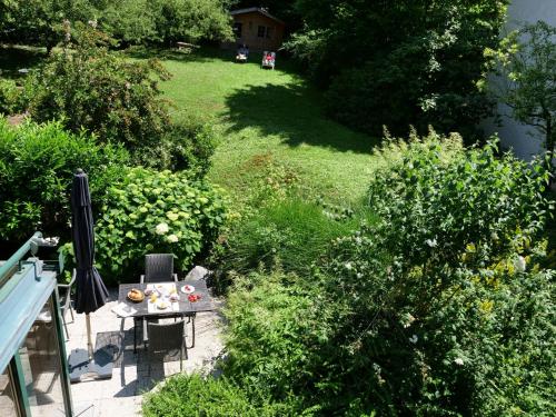 a garden with a table and chairs on a balcony at Hotel Garni Christl in Bad Griesbach