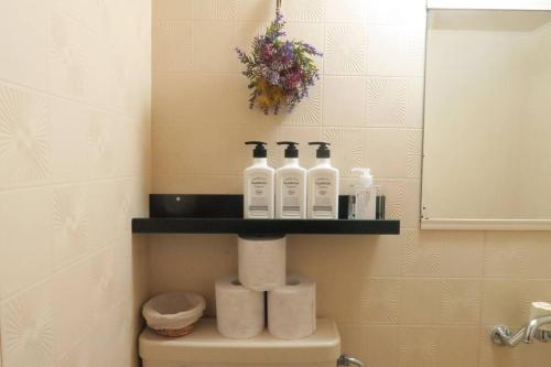 a bathroom with a shelf on the back of a toilet at A's Guest Room 303 in Osaka