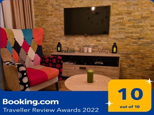 a living room with a tv on a brick wall at Hedonic in Kopaonik