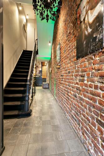 a brick hallway with stairs and a brick wall at Boutique Hotel Saint-Géry in Brussels