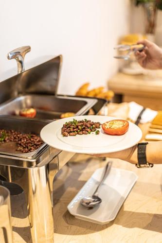 a table with a plate of food on a grill at Ramada by Wyndham Astana in Astana