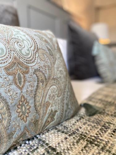 a close up of a pillow on a couch at White Hart Hotel in Dorchester on Thames