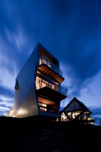 a building on top of a hill at night at The Pavilions at Mona in Hobart