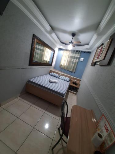a small room with a bed and a table at Hotel Luar in Sao Paulo