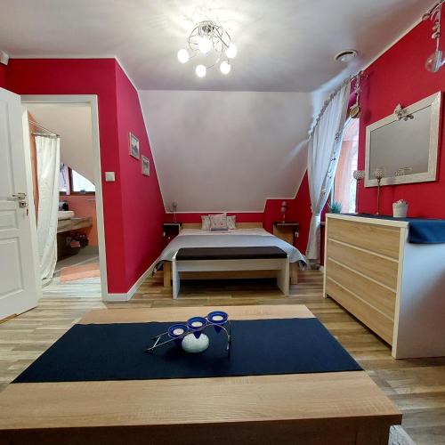 a bedroom with red walls and a bed with scissors at Villa Eva & Lilou Pod Rysianką in Żabnica