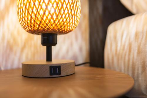a lamp sitting on top of a table at Bheaven I Skandi Premium Apartment in Bremerhaven