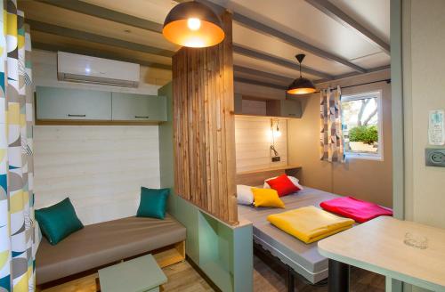 a small room with a bed in a tiny house at Camping la Croix du Sud in Saint-Tropez