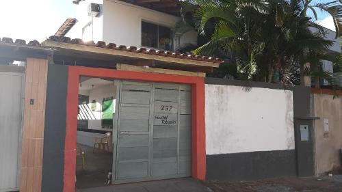 a building with a door with the number on it at Hostel Tabapiri in Porto Seguro