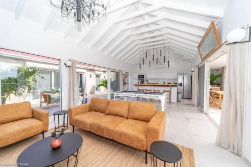 a living room with a couch and a table at VILLA ANGEL ROCK in Saint Barthelemy