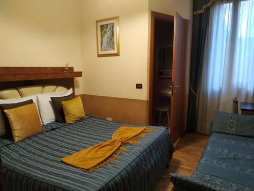 a hotel room with a bed with a towel on it at Atlantide Hotel in Venice