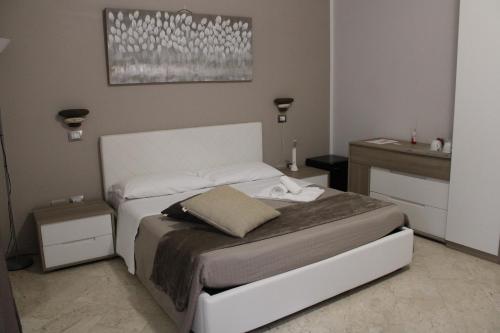 a bedroom with a white bed with two night stands at B&B D'Amari Affittacamere in Palermo