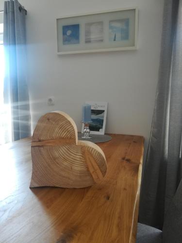 a wooden chair sitting on top of a wooden table at Apartmenthaus WALDHORN in St. Wolfgang