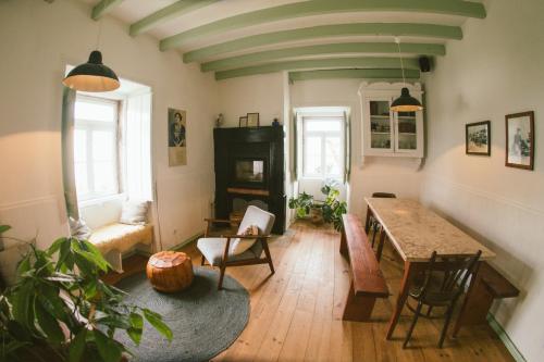 a living room with a table and a couch at Casa Paço D`Ilhas in Ericeira