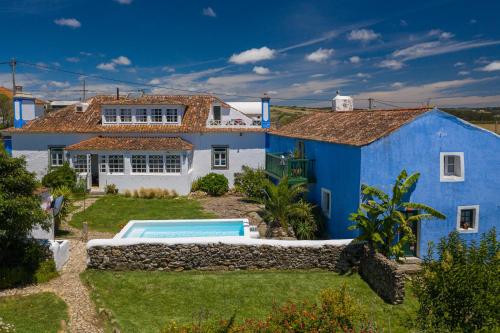 a blue and white house with a swimming pool at Casa Paço D`Ilhas in Ericeira