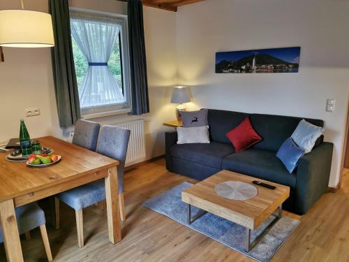a living room with a couch and a table at Apartmenthaus WALDHORN in St. Wolfgang