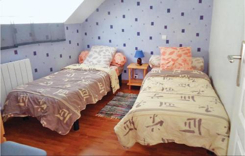 two beds in a room with purple walls at Awesome Home In Brhand With 2 Bedrooms And Wifi in Moncontour