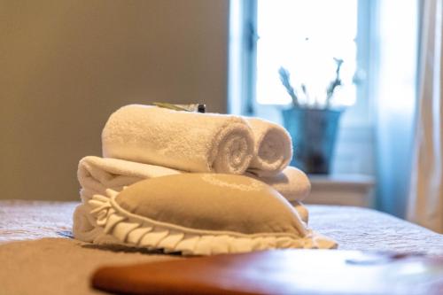a pile of towels sitting on top of a table at Hotel Ô Château in Hayange