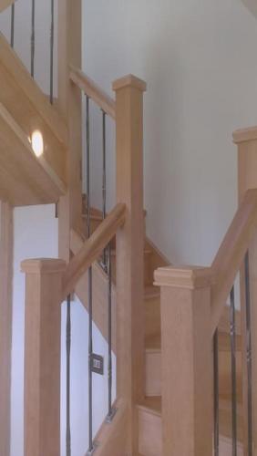 a wooden staircase in a house with glass railing at Tigh Eilidh (The Cabin on the Hill) in Breakish