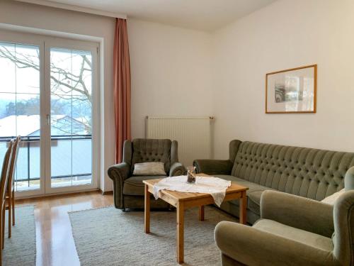 a living room with a couch and two chairs and a table at Apartment Meran-2 by Interhome in Görtschach