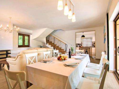 a dining room and kitchen with a table and chairs at Holiday Home Jadran - LBN310 by Interhome in Nedeščina