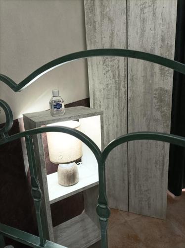a green bed frame with a lamp on a shelf at Home Sweet Home COSENZA in Cosenza