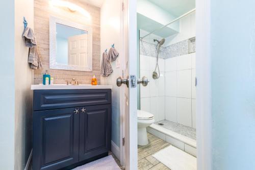 a bathroom with a blue cabinet and a sink at I Need A Vacay Now! Remodeled Studio in Daytona Beach