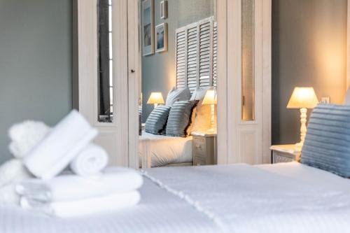 a bedroom with a bed and a mirror and a bed at Hotel Ô Château in Hayange